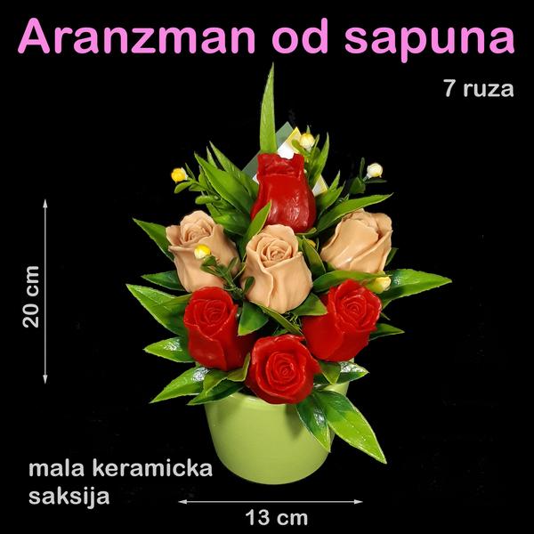 Crvene i krem ruže u maloj keramičkoj saksiji